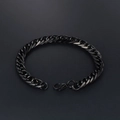 Minimalist black stainless steel chain bracelet with lobster clasp on grey background - Black