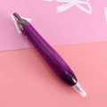 Creative eggplant-shaped ballpoint pen with green cap on pink background - Eggplant