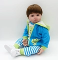 Realistic baby doll wearing a blue dinosaur hoodie with striped pants and white sneakers - Green Dinosaur