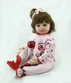 Lifelike reborn doll with brown hair in pink ladybug outfit and matching red socks - Brown Ladybug