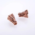 Detail of two antique bronze dragon head beads with intricate scale textures for jewelry - Antique Rose Gold