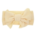Soft pale yellow stretch headband for infants featuring a large textured bow design - Milk White