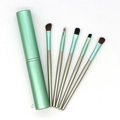 Close-up of five mint green eye makeup brushes with a matching cylindrical storage case - Mint Green