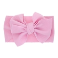 Elastic baby headband with large pink bow featuring textured waffle knit fabric - Pink