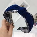 Dark blue knotted headband featuring gray and white paisley pattern fabric covering - Navy Blue