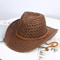 Close-up of woven raffia straw cowboy hat with adjustable drawstring and wide brim - Brown