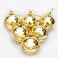 Set of six golden Christmas balls with glittery pine tree patterns on white plush background - Gold