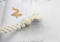 Detailed close-up of double-row pearl waist chain with a delicate bow buckle - Small Bow Silver