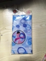 Blue and white patterned nylon exfoliating back scrubber in branded plastic packaging - Blue Floral Print