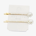 Detail view of pearl flower hair clips on a white card with golden metal finish - H184-1 (Pearl Flower)