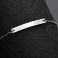 Nahaufnahme der polierten Edelstahl-ID-Platte eines minimalistischen Kinderarmbandes - Stahlfarbe