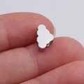 Close-up of a small 6x10mm silver cloud charm for DIY jewelry being held by fingers - 6x10mm / Steel