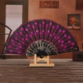 Handheld black folding fan featuring pink sequins and golden embroidery on wood stand - Rose Red