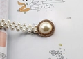 Close-up of elegant double-row pearl waist belt with rhinestone buckle and rose gold finish - Large Pearl Buckle