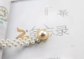 Detailed close-up of elastic waist belt with double row pearls and gold metal accent - Small Pearls Gold