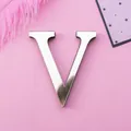 Glossy silver mirror acrylic letter V wall sticker with 3D effect on pink background - Letter V