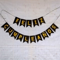 Spanish Feliz Cumpleaños birthday banner with black fishtail flags and yellow letters - Black Swallowtail Banner