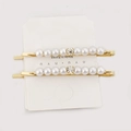 Set of two gold hair clips featuring elegant white pearls and a centered clear rhinestone - H184-2 (Double Row Pearl)