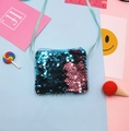 Close-up of mermaid sequin children's shoulder bag with colorful flat lay props. - Blue + Light Pink