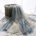 Blue and white gradient cotton linen scarf with frayed edges draped from a woven basket - Light Blue + White