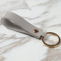 Gray pebble grain leather keychain with pale gold ring and minimalist loop design - Gray