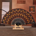 Black folding fan with gold embroidery and sequins on a classic wooden display stand - Orange