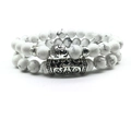 Detail of beaded bracelets with white howlite stone, silver Buddha head and floral spacers - Howlite