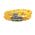 Ethnic double beaded bracelet with translucent yellow beads and Buddha head charm - Amber Color Glass