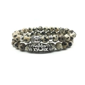 Detailed close-up of Buddhist head bead and patterned tube on Dalmatian Jasper bracelets - Dalmatian Jasper