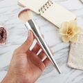 Large powder brush with two-tone fiber bristles and silver tapered handle held in hand - Silver Tri-color Hair