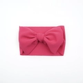 Elastic baby headband featuring a large rose pink fabric bow made of textured bubble fabric - Rose Red
