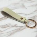 Minimalist pistachio green leather keychain with gold ring and polished metal clasp - Green