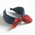 Retro bow headband in dark blue fabric with a contrasting red knot accent - Dark Red Bow