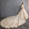 Luxurious champagne gold off-the-shoulder wedding gown with lace and long train - US 26W / Trailing