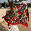 Ethnic print cotton linen scarf with red tassels shown at beach holiday scene - 180cm / Vivid Ethnic Red Tassel Style (L176)