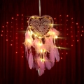 Pink heart-shaped dreamcatcher with LED lights and feathers on a red backdrop - MS0077BCD