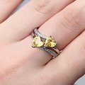 Elegant silver ring with dual interlocking yellow heart-shaped zircons on hand - US 6 / Yellow