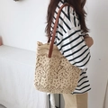 Detail shot of beige lace tote bag featuring floral crochet and brown leather strap - Brown