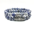 Detailed macro of natural blue sodalite beaded bracelets with silver Buddha head charm - Blue Spot Jasper