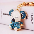 Golden koala keychain with blue rhinestones and a star-shaped gem detail - Blue