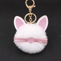 Close-up of white plush kitten keychain with pink glitter ears and gold metal clip - White