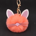Detail of fluffy orange pink cat head keychain with glitter ears and whiskers - Orange Red