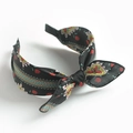 Close-up of retro floral pattern headband with bow detail on white background - Black Scarf Print Bow