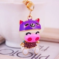 Cartoon pig keychain with purple helmet and crystal accents on a golden metal hook - Purple