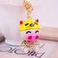 Cartoon pig keychain with yellow helmet and sparkling crystal diaper in gold finish - Yellow