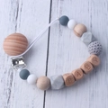 Detail of baby pacifier clip with wood beads, silicone balls and BABY letter engraving - Gray