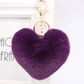 Detailed close-up of a soft purple heart-shaped plush keychain with a gold metal clasp - Deep purple