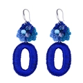 Detailed macro view of bohemian hand-knitted flower drop earrings with blue bead accents - Blue