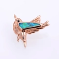 Macro shot of hummingbird pendant with rose gold plating and blue iridescent opal stone - Rose Gold Green Opal