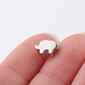 Macro shot of silver stainless steel elephant charm bead held by fingers for jewelry - 6*8mm Elephant Small Hole Bead / Steel